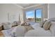 Inviting bedroom featuring calming colors, water views, and access to the outdoors through sliding glass doors at 20 Bellevue Dr, Treasure Island, FL 33706