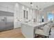 Bright, modern kitchen with stainless steel appliances, large island, and stylish pendant lighting at 20 Bellevue Dr, Treasure Island, FL 33706