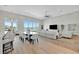 Open-concept living room leading to the dining area, complemented by floor-to-ceiling windows and waterfront views at 20 Bellevue Dr, Treasure Island, FL 33706