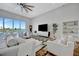 Bright living room with large windows, waterfront views, and comfortable seating at 20 Bellevue Dr, Treasure Island, FL 33706