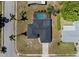 An aerial view of a home with an in-ground pool surrounded by a screened-in enclosure and mature landscaping at 2008 41St W St, Bradenton, FL 34205