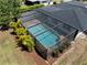 Aerial view of a screened pool and patio, and lush landscaping around the property at 2008 41St W St, Bradenton, FL 34205