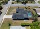 An aerial view of the home with a screened pool, gray roof, and spacious yard at 2008 41St W St, Bradenton, FL 34205