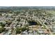 An aerial view of a quiet residential neighborhood with single Gathering homes, mature trees, and a pond at 2008 41St W St, Bradenton, FL 34205