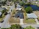 An aerial view of a single Gathering home with mature trees, a well-manicured lawn and a backyard pond at 2008 41St W St, Bradenton, FL 34205