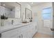 Bright bathroom with dual sinks, quartz countertops, modern fixtures, and a shower with white marble-style tile at 2008 41St W St, Bradenton, FL 34205