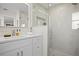 Sleek bathroom featuring white marble walls, glass shower, and modern fixtures at 2008 41St W St, Bradenton, FL 34205