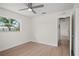 Bright bedroom with wood floors, ceiling fan, large windows, and access to hallway at 2008 41St W St, Bradenton, FL 34205