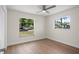 Bright bedroom with wood floors, ceiling fan, and two large windows overlooking the neighborhood at 2008 41St W St, Bradenton, FL 34205