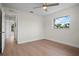 Bright bedroom with wood floors, ceiling fan, and a large window offering plenty of natural light at 2008 41St W St, Bradenton, FL 34205