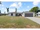 Charming single-story home featuring a well-manicured lawn and a two-car garage and green entry door at 2008 41St W St, Bradenton, FL 34205