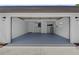 Spacious garage with a gray epoxy floor, white walls, storage cabinets, and utility connections at 2008 41St W St, Bradenton, FL 34205
