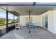 Screened patio with an outdoor dining area and lounge chairs at 2008 41St W St, Bradenton, FL 34205