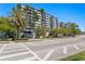 The exterior view of the building is complemented by palm trees and green foliage at 201 W Laurel St # 212, Tampa, FL 33602