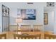 Close up of the dining area, featuring a wooden table and chairs and view of an ocean-themed painting at 201 W Laurel St # 212, Tampa, FL 33602