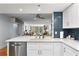 Bright open kitchen showcases white cabinetry, stainless steel appliances, and breakfast bar seating at 201 W Laurel St # 212, Tampa, FL 33602