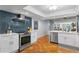 Spacious kitchen with stainless appliances, white cabinets, and a view to the living and dining spaces at 201 W Laurel St # 212, Tampa, FL 33602