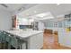 Open-concept kitchen with a large island, modern appliances, and terra cotta flooring throughout at 201 W Laurel St # 212, Tampa, FL 33602