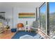 A sunny living room with a colorful painting and access to the balcony at 201 W Laurel St # 212, Tampa, FL 33602