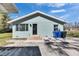 Side view of home with visible refuse containers at 209 E Lutz Lake Fern Rd, Lutz, FL 33549