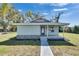 Charming single-story home with a covered porch, light blue paint, and stone accents at 209 E Lutz Lake Fern Rd, Lutz, FL 33549