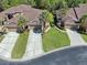Aerial view of a property with a well-maintained lawn, mature landscaping, and a two-car garage at 2206 Preservation Dr # 2206, Plant City, FL 33566