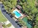 Aerial view of a community pool, with lounge chairs, tables, and access to a canal at 2206 Preservation Dr # 2206, Plant City, FL 33566