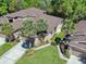 Aerial view of a well-maintained property with a two-car garage, mature landscaping, and a sidewalk at 2206 Preservation Dr # 2206, Plant City, FL 33566