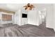 Spacious bedroom features neutral carpeting, ceiling fan, television, and access to an enclosed lanai at 2206 Preservation Dr # 2206, Plant City, FL 33566