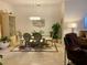 Elegant dining room with modern chandelier, seating for six, and view to living area at 2206 Preservation Dr # 2206, Plant City, FL 33566