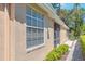Exterior side view shows a large window and walkway with manicured landscaping, adding to its appeal at 2206 Preservation Dr # 2206, Plant City, FL 33566