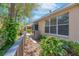 Rear exterior view showing manicured landscaping, walkway and screened in porch providing an inviting outdoor space at 2206 Preservation Dr # 2206, Plant City, FL 33566