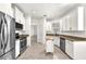 Bright kitchen with stainless appliances, white cabinets and a kitchen island at 2206 Preservation Dr # 2206, Plant City, FL 33566