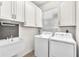 Functional laundry room with sink, washer, dryer, and ample cabinet space at 2206 Preservation Dr # 2206, Plant City, FL 33566