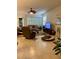 Spacious living room with tile flooring, ceiling fan, large windows, leather furniture, and a flatscreen TV at 2206 Preservation Dr # 2206, Plant City, FL 33566