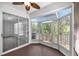 Enclosed sunroom featuring large windows, ceiling fan and exterior access providing a bright and airy space at 2206 Preservation Dr # 2206, Plant City, FL 33566