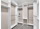 This organized walk-in closet features shelving, hanging rods, and neutral carpeting at 2206 Preservation Dr # 2206, Plant City, FL 33566