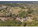 Expansive aerial view of a home nestled on sprawling acreage with mature trees and verdant landscaping at 22295 Powell Rd, Brooksville, FL 34602
