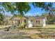 Charming single-story home with a covered porch and lots of surrounding trees at 22295 Powell Rd, Brooksville, FL 34602