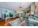 Bright living room featuring hardwood floors, a ceiling fan, and sliding glass doors to a patio at 2657 Crystal Circle Cir, Dunedin, FL 34698