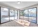 Bright sunroom featuring beautiful wood floors, recessed lighting, and large glass sliding doors to backyard at 3246 Fox Lake Dr, Tampa, FL 33618