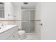 Bathroom with white vanity, toilet, and glass-enclosed shower at 330 Brandy Wine Dr # 330, Largo, FL 33771