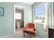 Cozy bathroom view from bedroom with a comfortable chair and natural light streaming from the window at 330 Brandy Wine Dr # 330, Largo, FL 33771