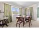 Cozy dining room featuring a round table, ample natural light, and traditional curtains at 330 Brandy Wine Dr # 330, Largo, FL 33771