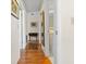 Hallway with wood flooring connecting to bathroom and other rooms, showcasing neutral decor at 330 Brandy Wine Dr # 330, Largo, FL 33771