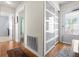 Hallway with wood flooring and glass paneled closet doors offering bright, light-filled spaces at 330 Brandy Wine Dr # 330, Largo, FL 33771
