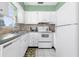 Bright kitchen with white appliances and cabinets, offering a clean and practical space at 330 Brandy Wine Dr # 330, Largo, FL 33771