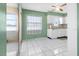 Eat in kitchen with clean white tile flooring, cabinets, and access to outdoor patio at 330 Brandy Wine Dr # 330, Largo, FL 33771