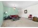 Cozy living room featuring a futon, vintage chandelier, and neutral carpeting at 330 Brandy Wine Dr # 330, Largo, FL 33771