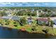 Aerial view highlighting a residential property featuring a pool and dock access to a serene pond at 3381 Conway Blvd, Port Charlotte, FL 33952